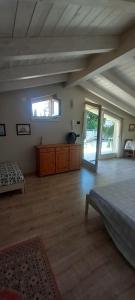 a large bedroom with a large bed and wooden floors at Casa 33 in Gardone Riviera