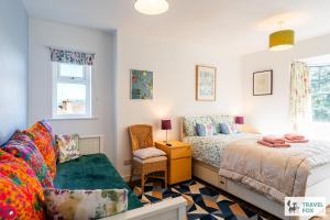 a bedroom with two beds and a chair at Springfield House in Cheadle