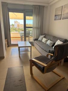 a living room with a couch and a table at Dumar Puerto Rey in Vera +15 photos