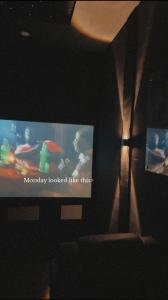 a tv in a living room with a television screen at ZEELUX Apartment in Ikuata