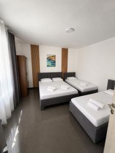 a room with three beds in a room at Guest house, Small beach in Ulcinj