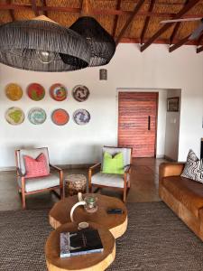 a living room with a couch and a table at MANZINI RIVER HOUSE - Mjejane Private Game Reserve, Greater Kruger National Park in Hectorspruit