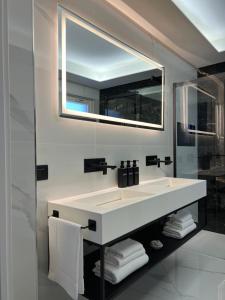 a bathroom with a white sink and a mirror at Green House in Vico Equense