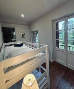 a bedroom with a bunk bed and a large window at Les gîtes in Daubeuf-Serville +2 photos