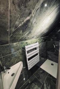a bathroom with a sink and a ceiling at Les gîtes in Daubeuf-Serville