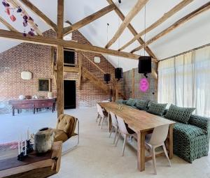 a living room with a table and a couch at Chambre d'hôtes Cocotte & Bigoudi in La Ferté-Beauharnais
