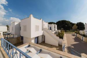 a view of a building from a balcony at Quintino Apartments Pool in Torre Lapillo