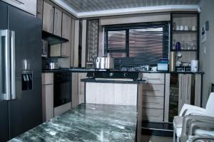 a kitchen with a stove and a counter top at Dam View Guest house in Bokong