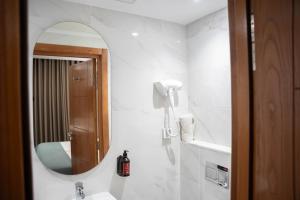 a bathroom with a mirror and a sink at Hôtel Passage in Tunis +80 photos
