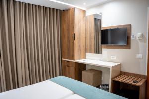a hotel room with a desk and a television at Hôtel Passage in Tunis
