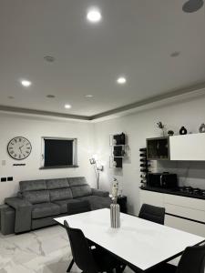 a living room with a couch and a table at Green House in Vico Equense +24 photos