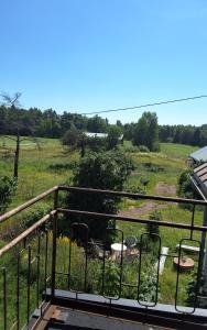 a view of a field from a balcony at Sundqvistens vinden in Emkarby