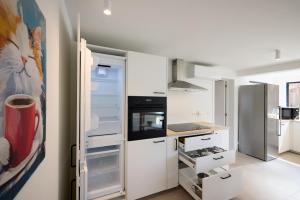 a kitchen with an open refrigerator and a stove at De Ontspannerij in Lille +37 photos