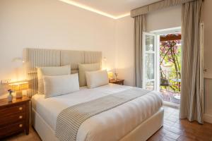 a bedroom with a large white bed and a window at Santavenere Hotel - The Leading Hotels of the World in Maratea +85 photos