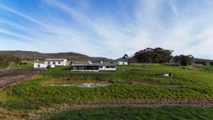 an aerial view of a house in a field at Landmeterskop in Stanford