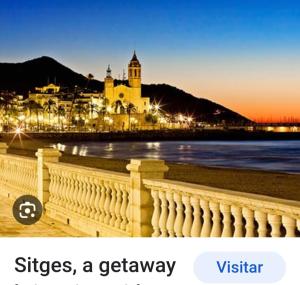 a view of a city with a building and the ocean at apartamento cerca playa ,estación tren y garaje gratis in Segur de Calafell