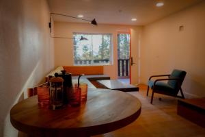 a living room with a wooden table in a room at Arkouda House in Big Bear Lake