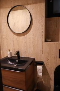 a bathroom with a sink and a mirror on the wall at AleA Central Studio Art Museum in Craiova +4 photos