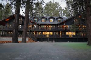 an exterior view of a large house with trees at Arkouda House in Big Bear Lake