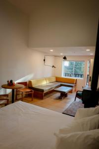 a living room with a couch and a table at Arkouda House in Big Bear Lake