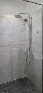 a shower with a glass door in a bathroom at The Lennox Premier Suites in Accra +32 photos