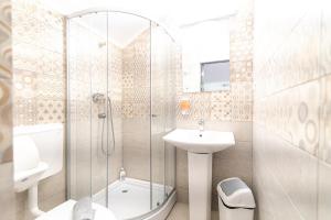 a bathroom with a shower and a sink and a toilet at Hanu Satului in Constanţa +143 photos