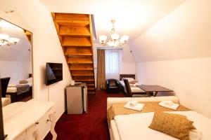 a room with two beds and a sink and a mirror at Hanu Satului in Constanţa