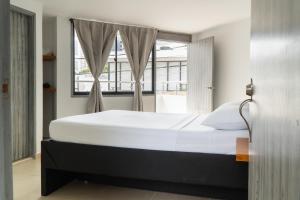a bedroom with a large bed and a window at Hotel Tayronaka in Santa Marta +27 photos