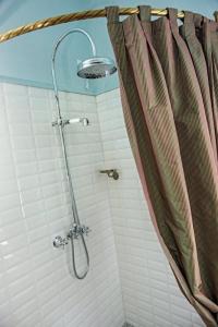 a shower in a bathroom with a shower curtain at il MOLENDINO in Calci