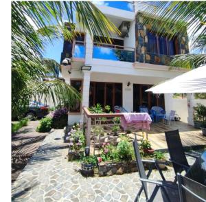 a house with a table and chairs in front of it at Georgios Villa in Grand-Baie