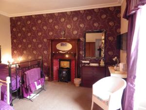 a bedroom with a bed and a vanity and a mirror at Sorbietrees B&B in Newcastleton