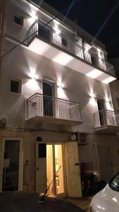 a white building with two balconies on top of it at Terrazza sul Borgo in Polignano a Mare