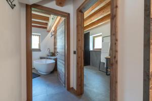 a bathroom with a white tub and a sink at Chalet Grifone - Chalet Maso Vecchio nel cuore del Lagorai Trentino in Castello Tesino +61 photos