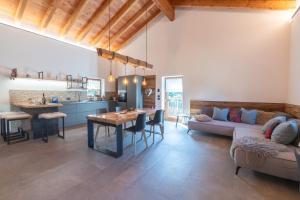 a living room with a couch and a dining room at Chalet Grifone - Chalet Maso Vecchio nel cuore del Lagorai Trentino in Castello Tesino