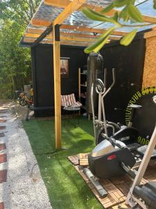 a backyard with a gym with green grass at Cosy house studio in Saint-Aunès