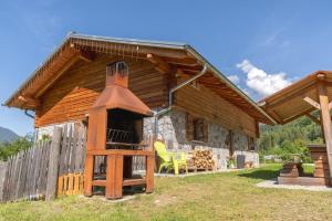a log cabin with a bell tower in front of it at Chalet Grifone - Chalet Maso Vecchio nel cuore del Lagorai Trentino in Castello Tesino