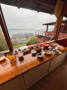 a table with food on it with a view of the ocean at Hostel Inn Bariloche in San Carlos de Bariloche +64 photos