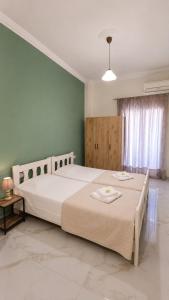 a bedroom with a large bed in a room at Ioannis Schinas Studios in Loutra Edipsou