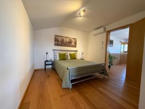 a bedroom with a bed and a wooden floor at Castelo 48 in Lamego