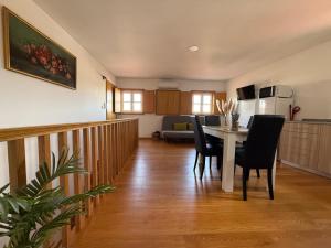 a kitchen and living room with a table and chairs at Castelo 48 in Lamego