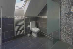 a bathroom with a toilet and a glass shower at Chambre d'hôtes près du Château in Sully-sur-Loire +23 photos