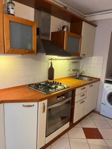 a kitchen with a stove top oven next to a sink at Dzirciema apartment in Riga