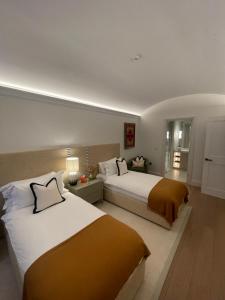 a hotel room with two beds and a window at The City Hotel London in London +31 photos