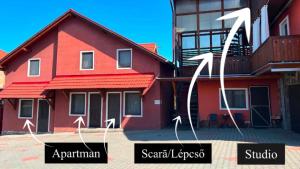 a red house with arrows pointing to different buildings at Pensiunea Melinda in Praid