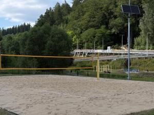 a basketball court with a net and a street light at Apartament Snooze in Jedlina-Zdrój +2 photos