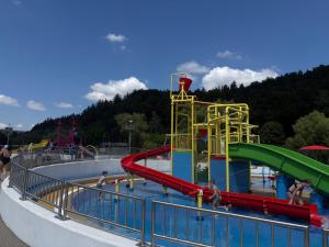 a water park with people playing in a water slide at Apartament Snooze in Jedlina-Zdrój