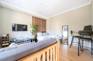 a room with a bedroom with a bed and a desk at Chic Flat Hideaway with Private Courtyard - Pass the Keys in Guildford