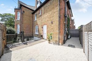 an exterior view of a brick building with a gate at Chic Flat Hideaway with Private Courtyard - Pass the Keys in Guildford
