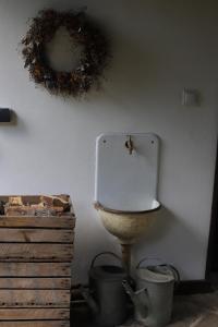 a bathroom with a toilet and a wreath on the wall at Pod Buchtou in Daňkovice +25 photos