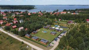 an aerial view of a small village with houses and cars at Twoje Rydzewo in Rydzewo